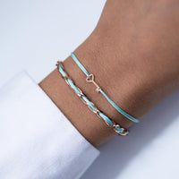 Set aus Armband Unico und Schlüssel-Armband, 925 Sterling Silber rosé vergoldet, Textilband türkis, am Handgelenk getragen